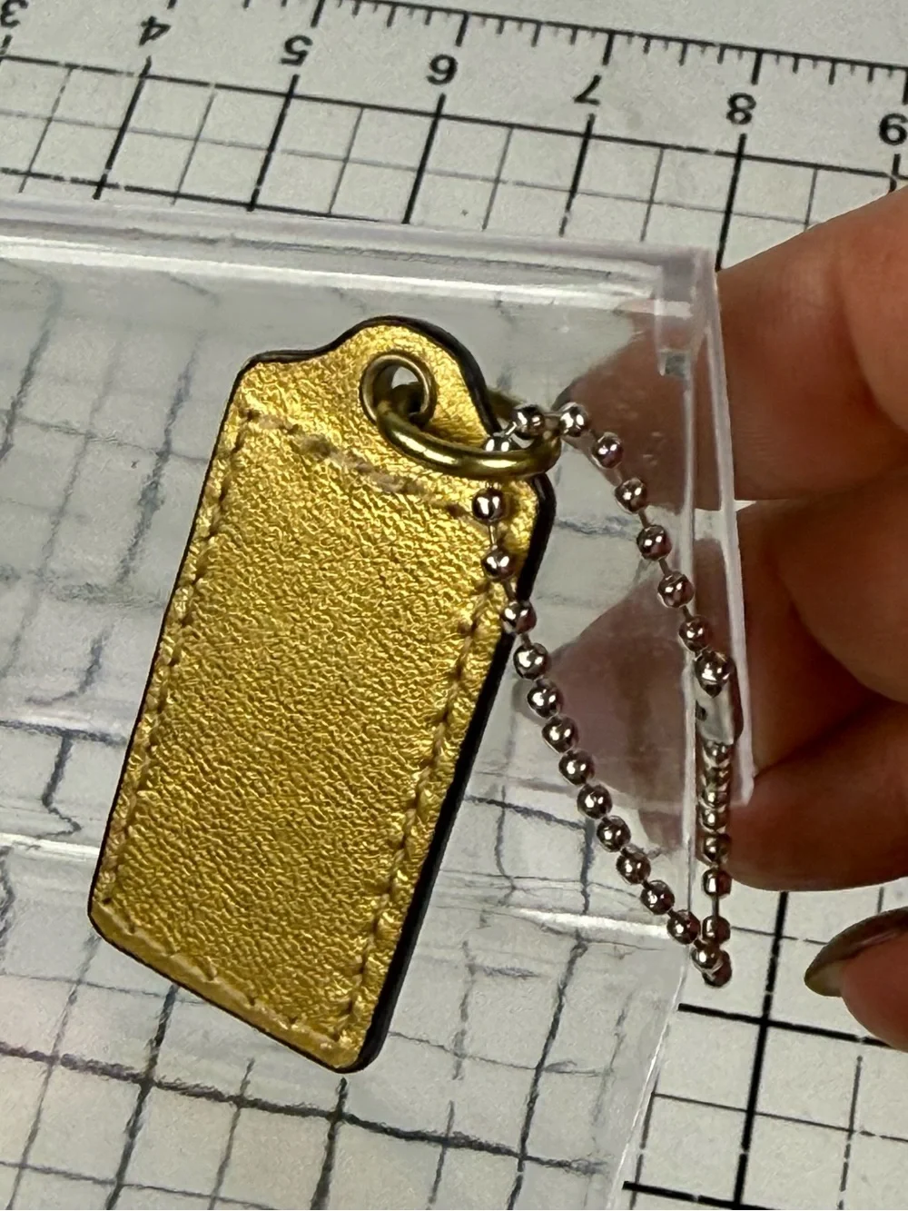 Coach two tone embossed gold front & metallic Leather back hang tag Key w Chain